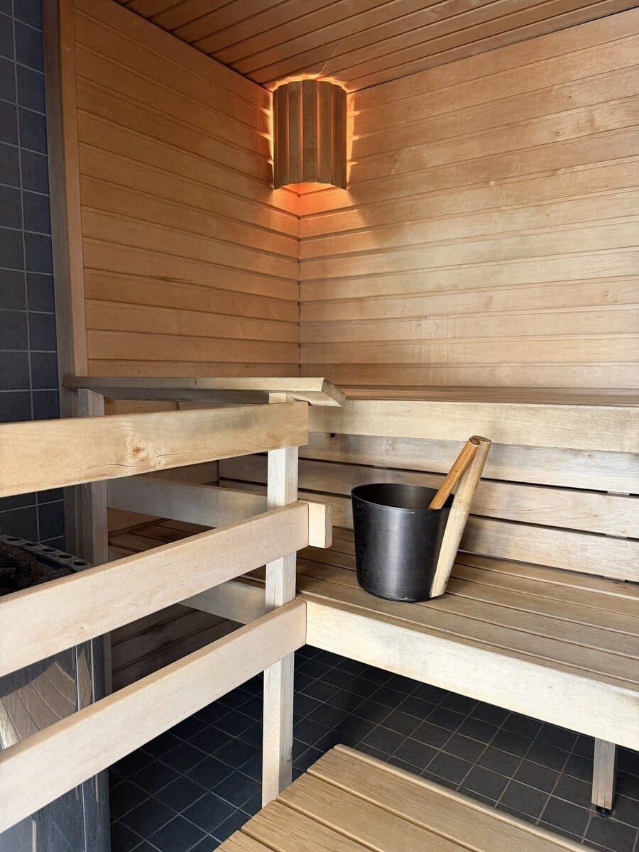 Traditional Finnish sauna interior with wooden bench and stones